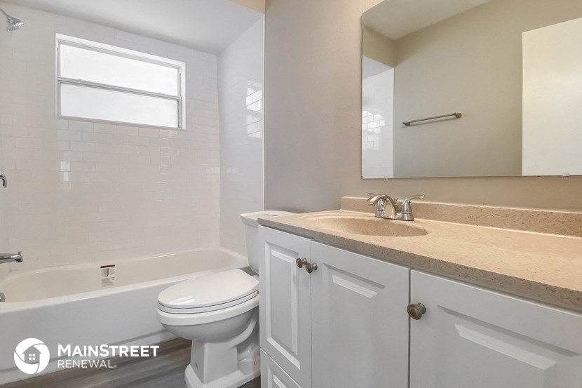 a bathroom with a sink and a toilet and a bath tub