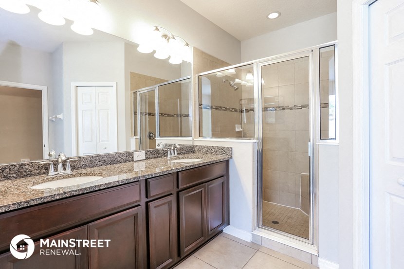 a bathroom with two sinks and a shower