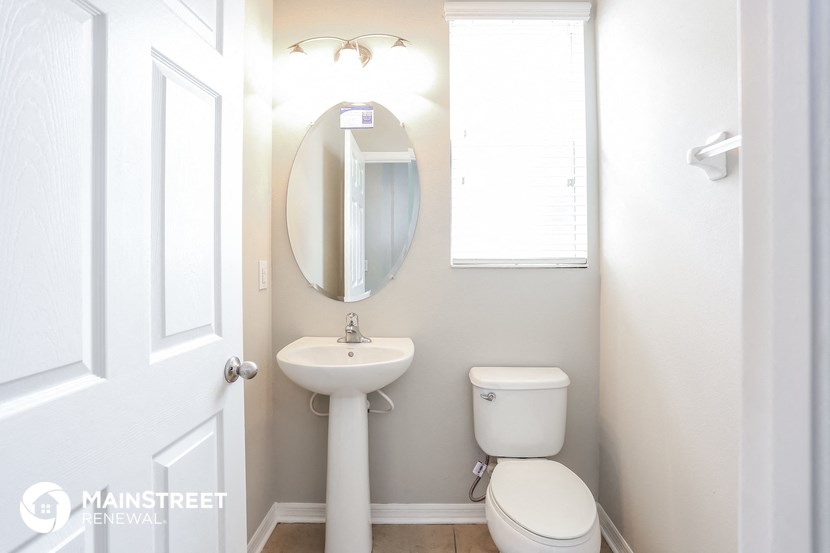a small bathroom with a sink toilet and a mirror