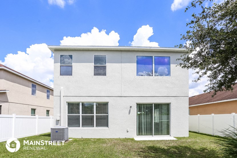 a white house with a yard in front of it