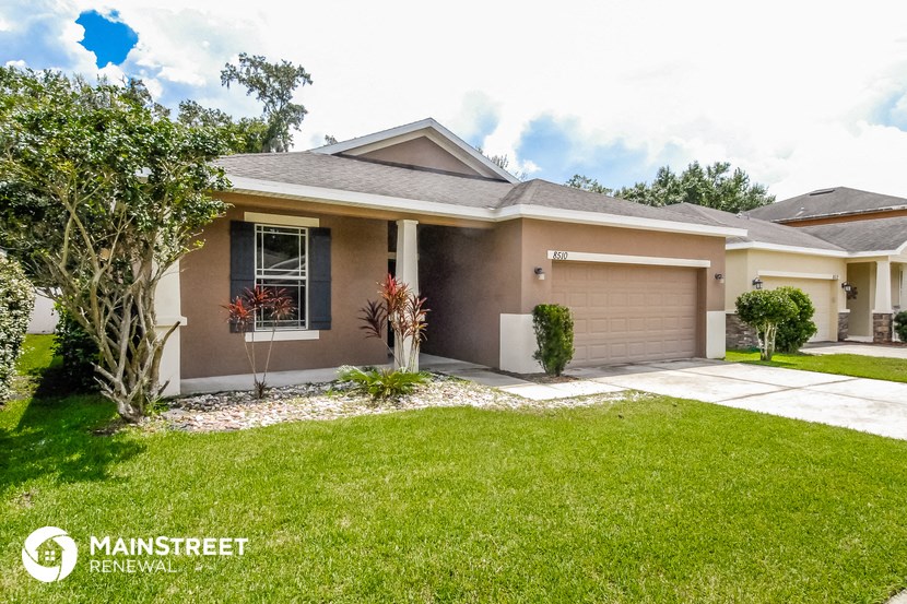 a home with a lawn and a driveway