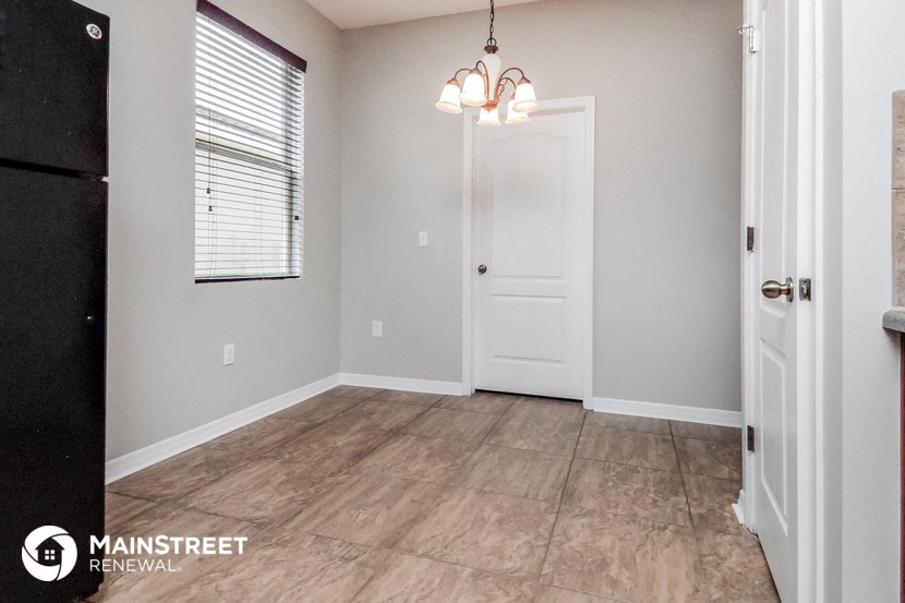 an empty room with a white door and a window