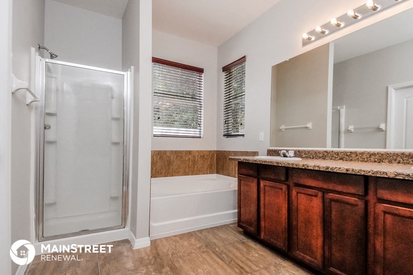 a bathroom with a shower and a sink and a bath tub