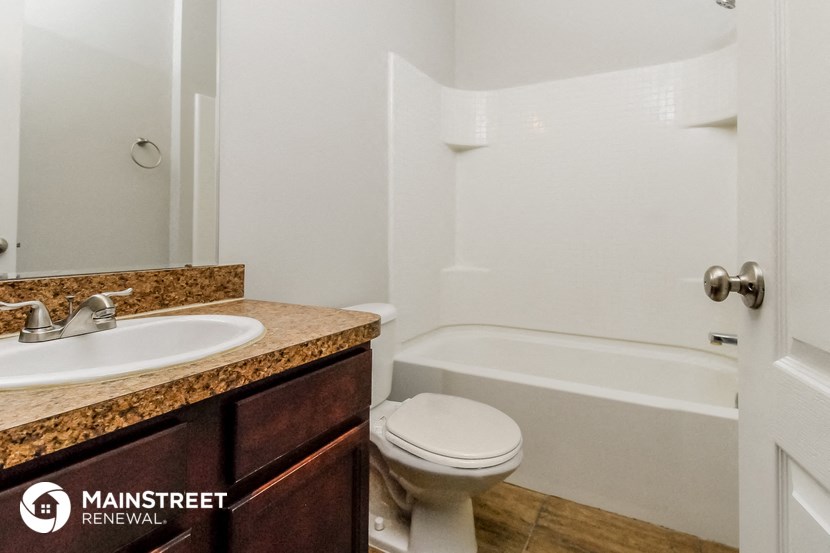 a bathroom with a sink toilet and a bath tub