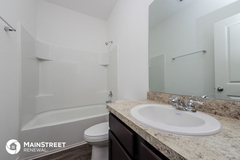 a bathroom with a sink and a shower and a toilet