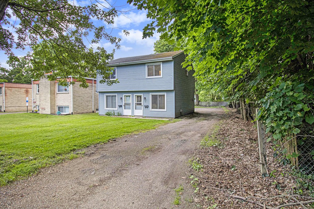 a view of a church with a field of grass in front of it