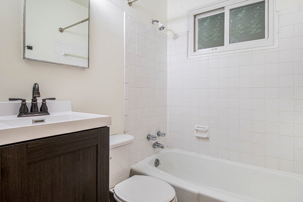 a bathroom with a sink toilet and a bath tub