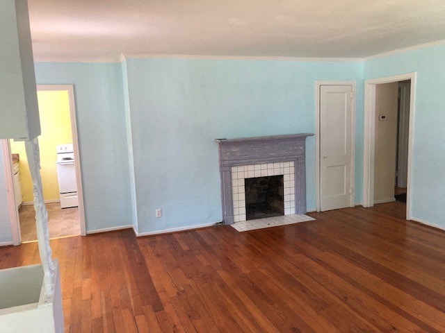 a living room with a fireplace and a wooden floor