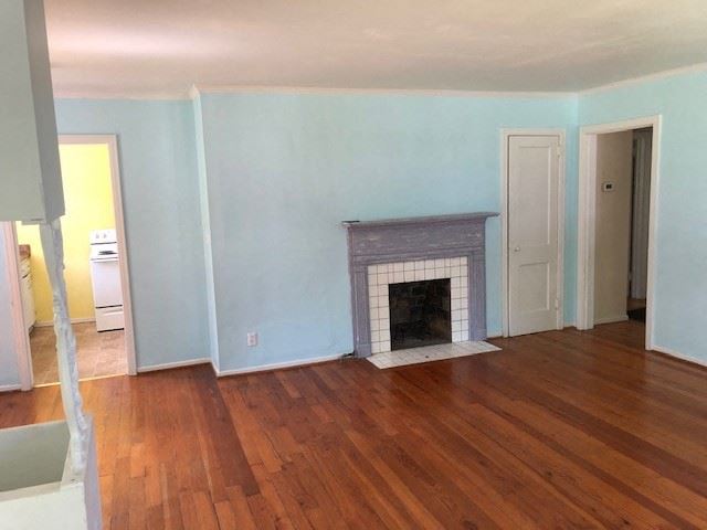 a living room with a fireplace and a wooden floor