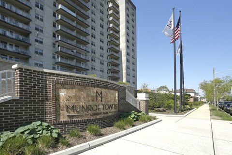 A brick building with a sign that says Munroe Tower.