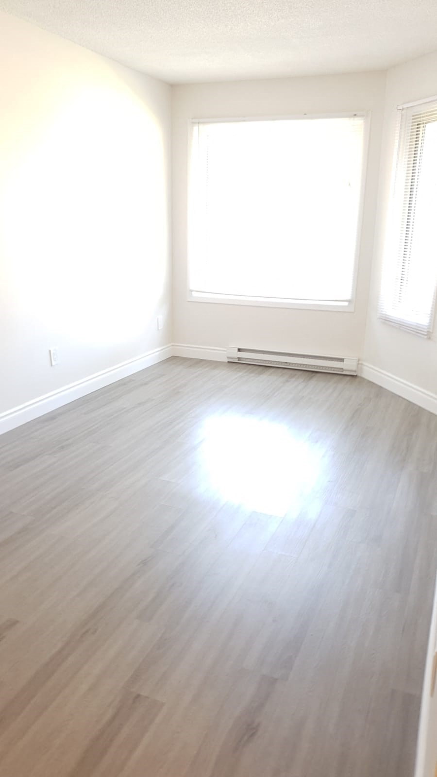 an empty room with a hard wood floor