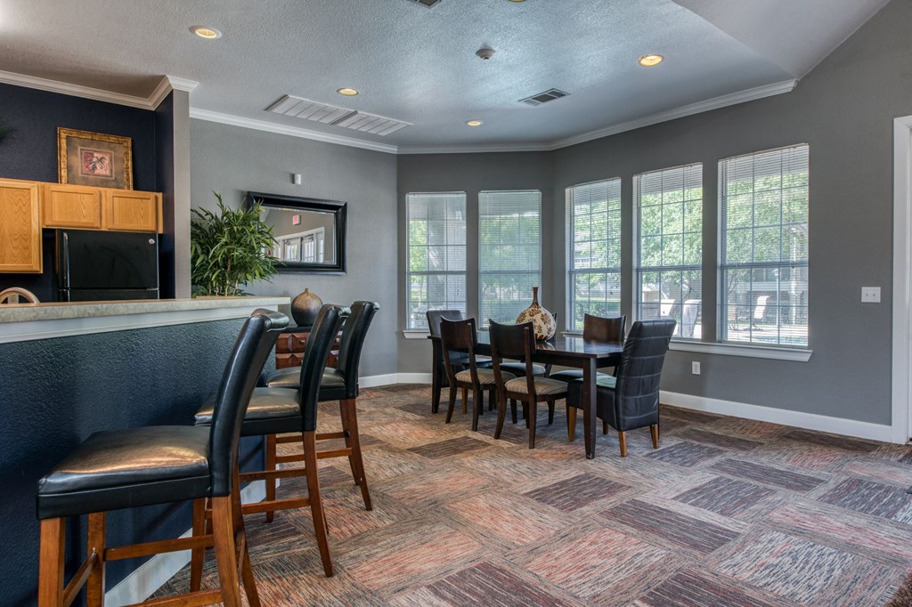 a dining room with a table and chairs and a bar