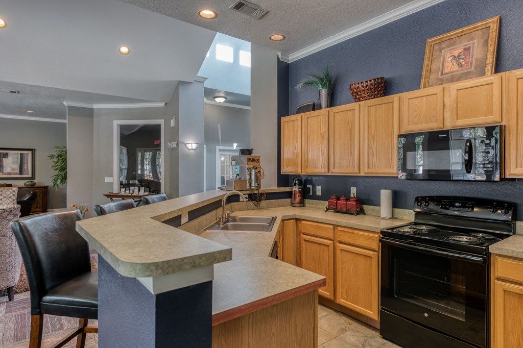 a kitchen with an island and a stove and a sink