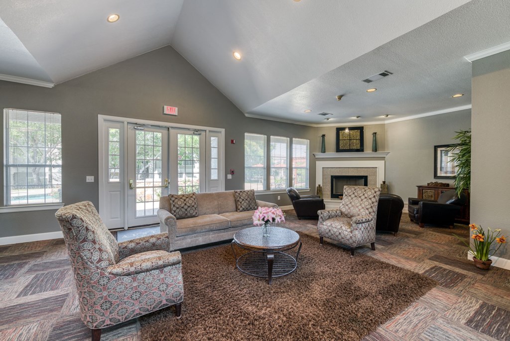 a living room with couches and chairs and a fireplace