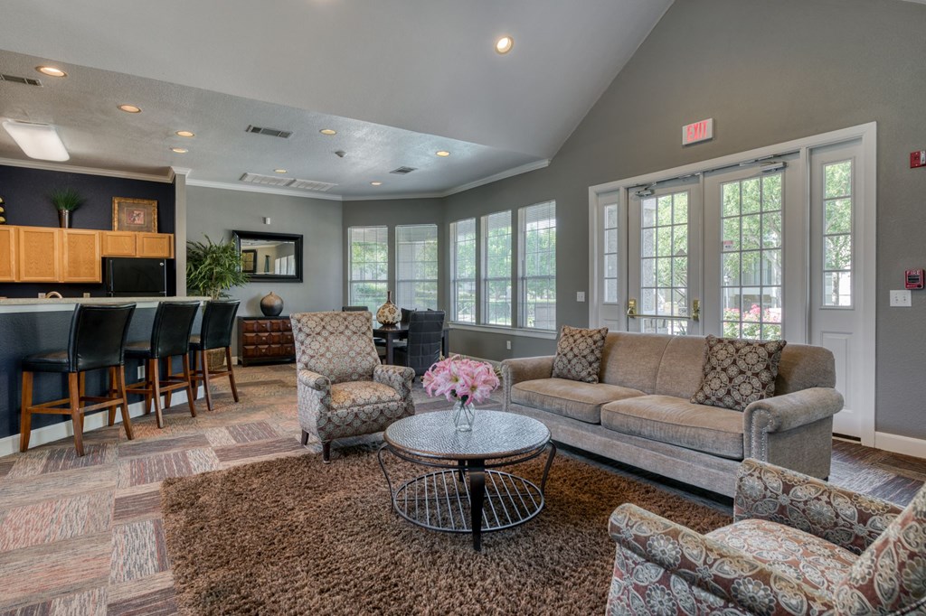 a living room with couches and chairs and a table