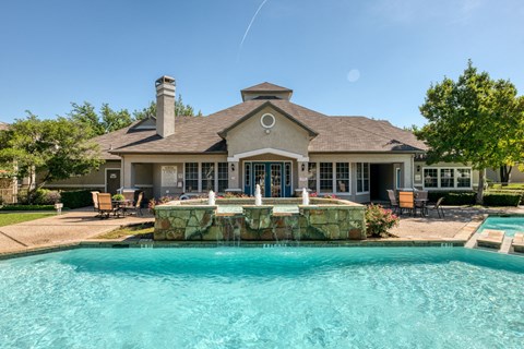 a large swimming pool in front of a house