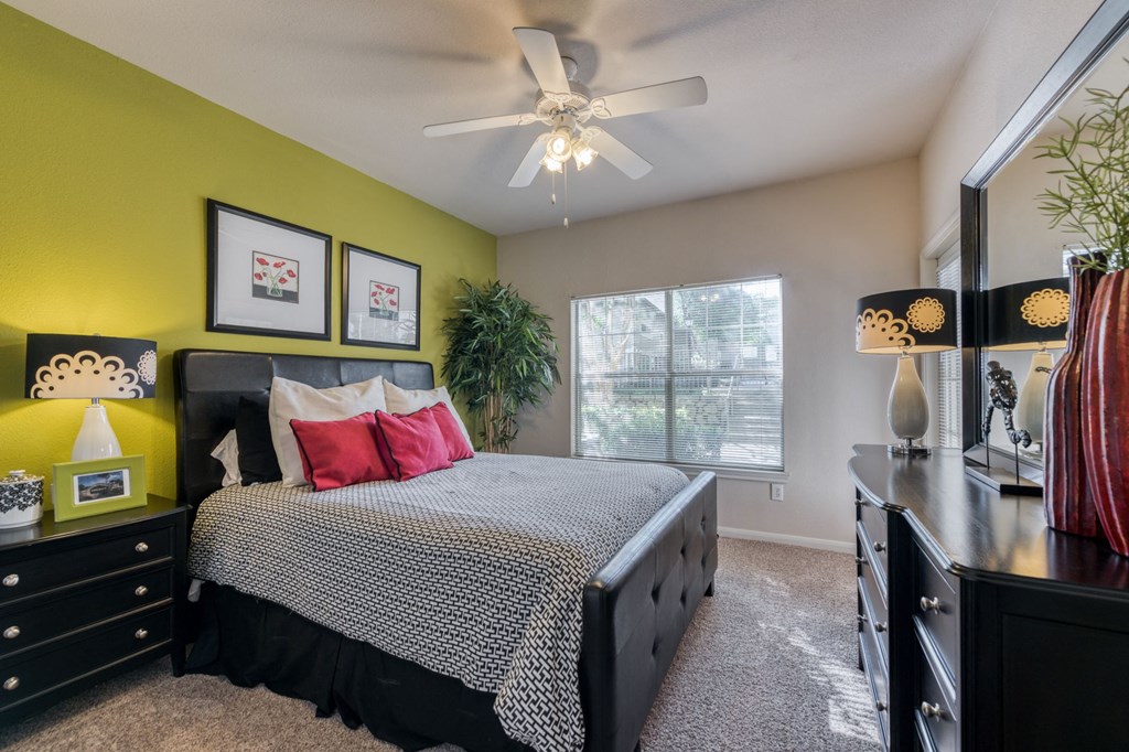 a bedroom with a bed and a ceiling fan