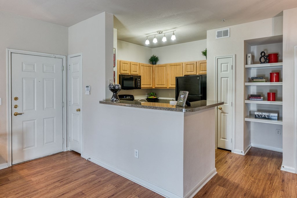 the view of a kitchen and living room with a large counter top