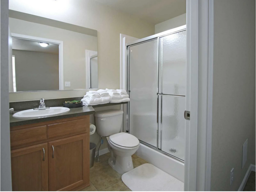 a bathroom with a sink toilet and a shower