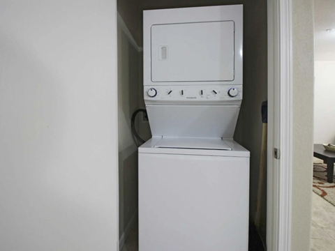 a white washer and dryer in a white room