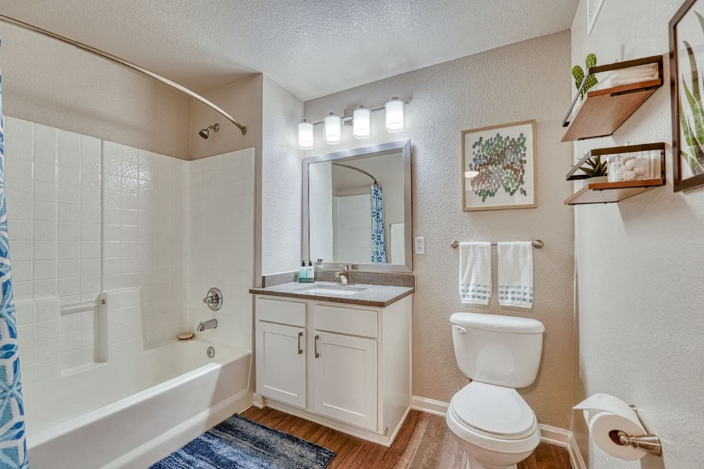 a bathroom with a toilet sink and a bath tub