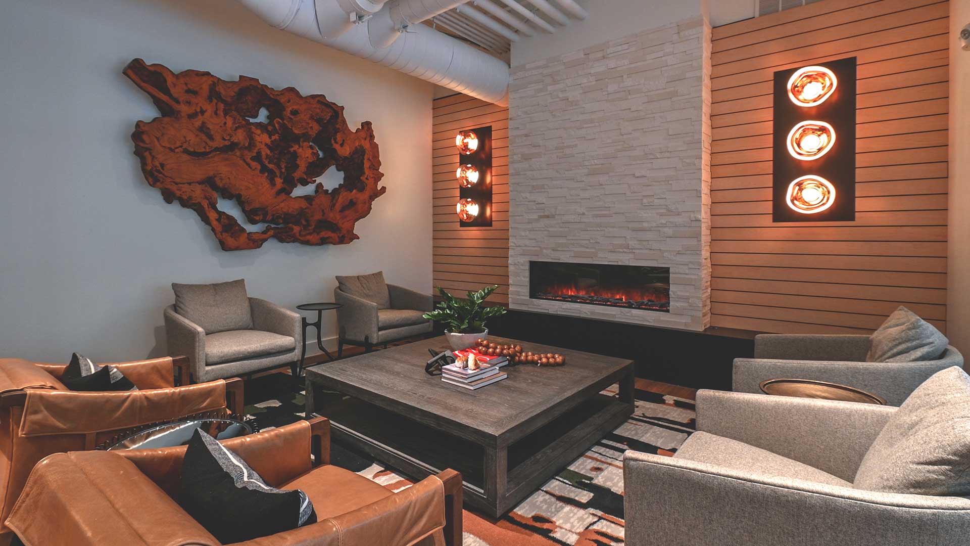 a living room with couches and chairs and a fireplace