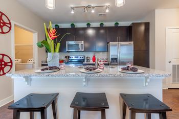 Kitchen with chair and counter topat Prairie Creek Apartments & Townhomes, Lenexa, KS
