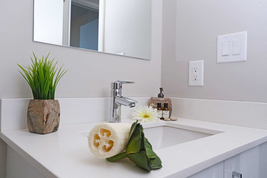a white bathroom with a sink and a mirror