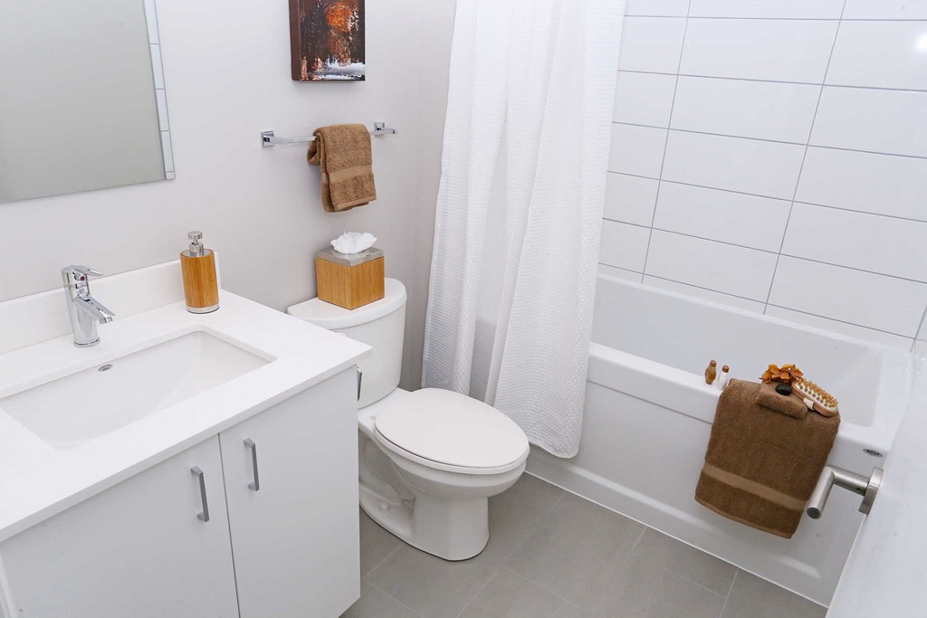 a white bathroom with a sink toilet and tub