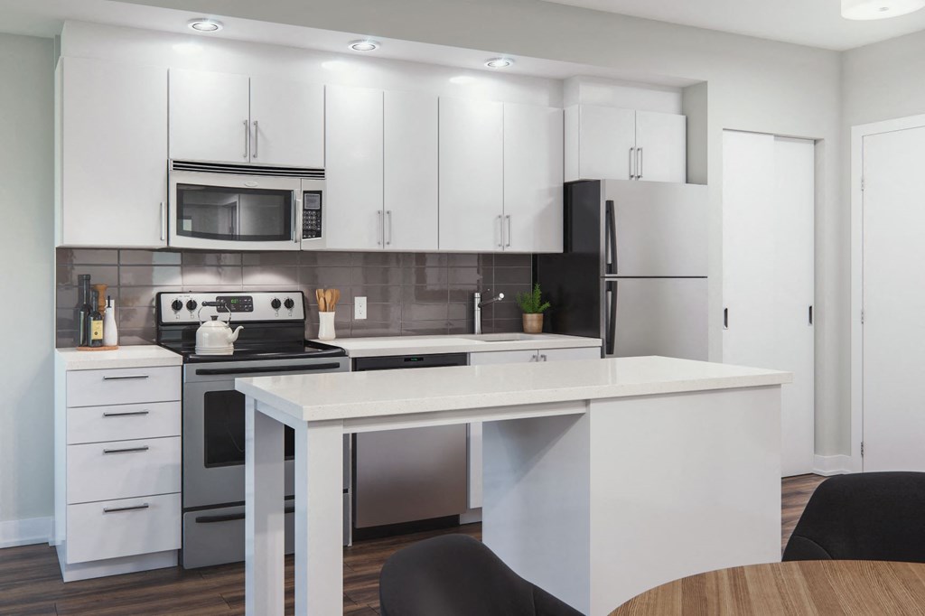 a kitchen with white cabinets and a white counter top
