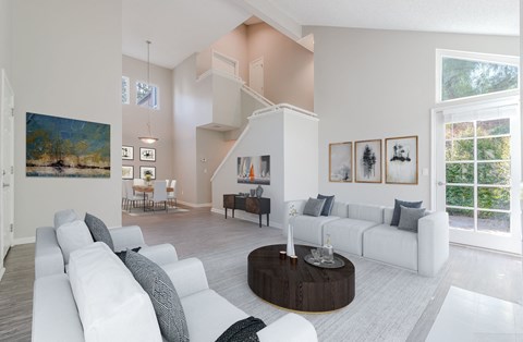 A living room with a white couch and a coffee table.