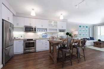 Kitchen with stainless steel appliances and dining area