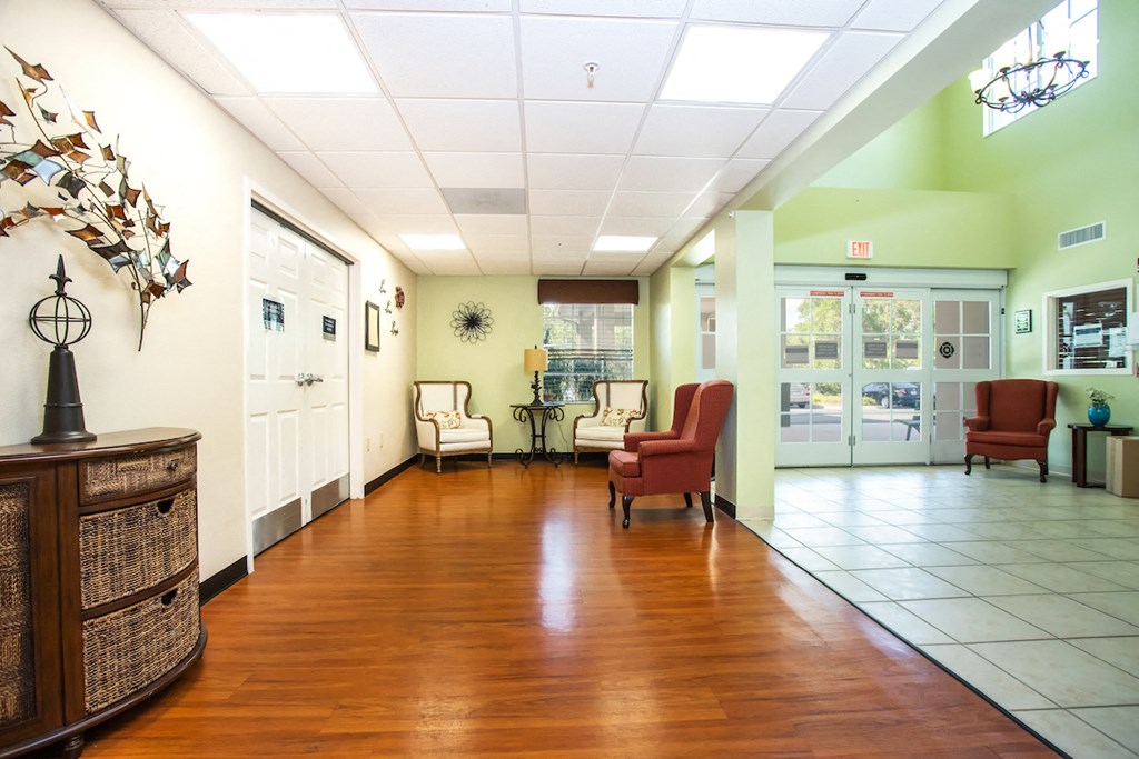 lobby of Villa Vincente with tile & wood-style floor and mailbox bank in wall
