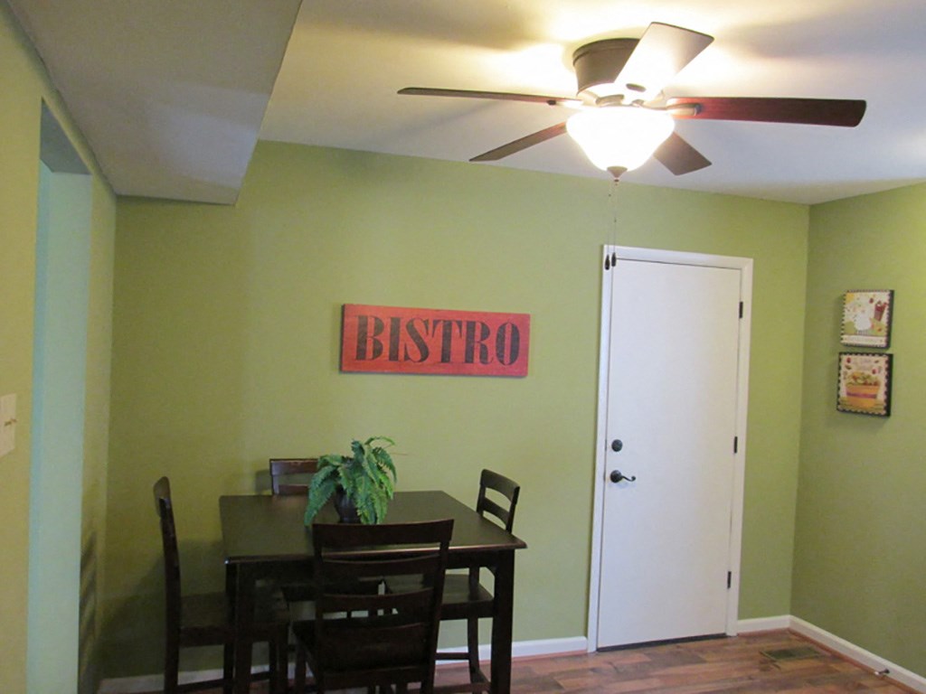a dining room with a table and a ceiling fan