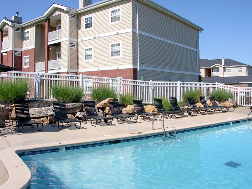 a swimming pool with a building in the background