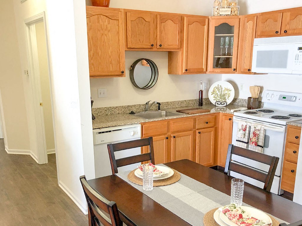 a kitchen and dining area with a table and chairs