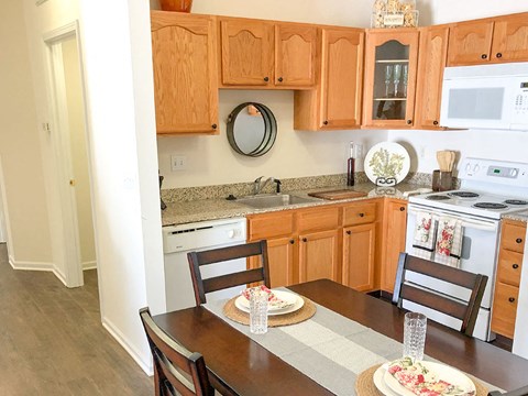 a kitchen and dining area with a table and chairs