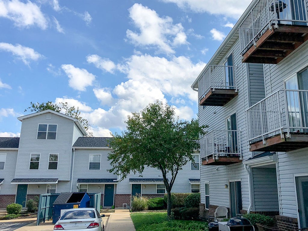 a row of houses with balconies and a tree