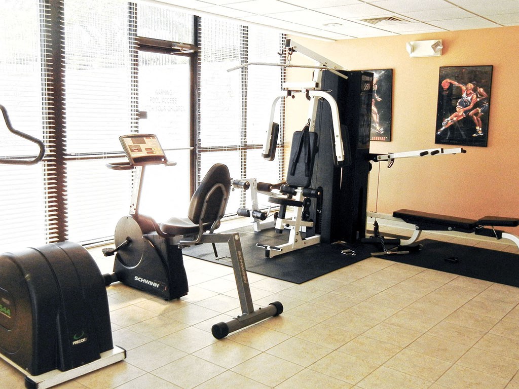 a gym with weights and other equipments in a home gym