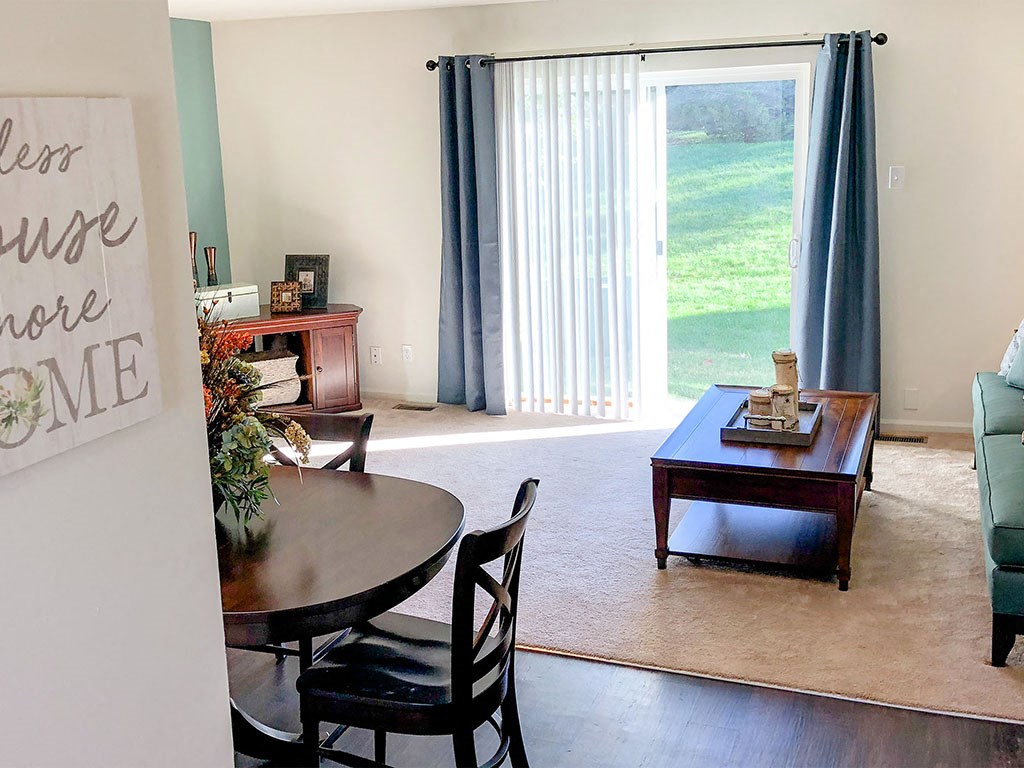 a living room with a table and a window