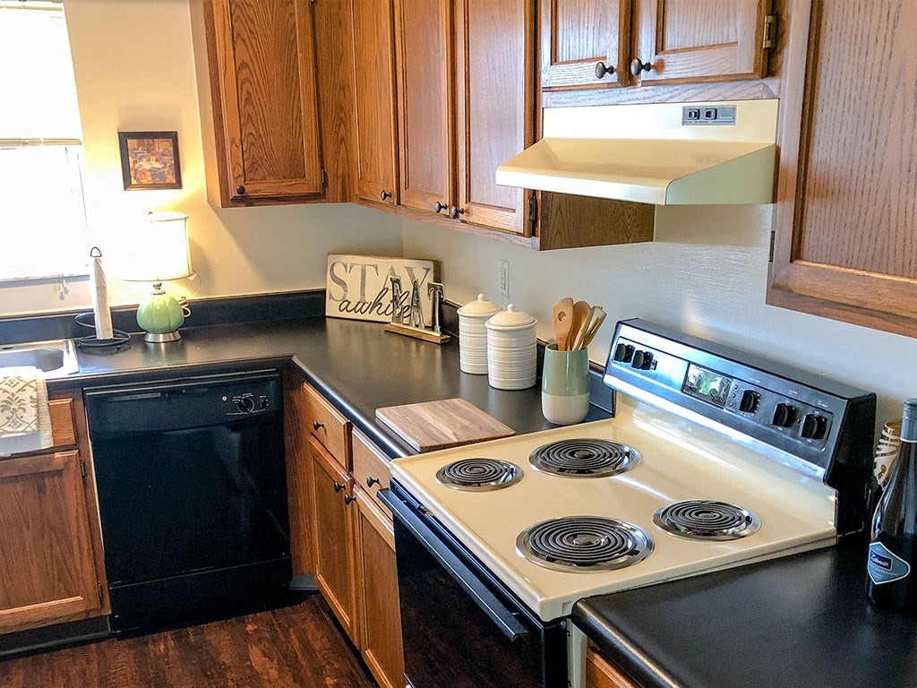a kitchen with a stove top oven and a sink