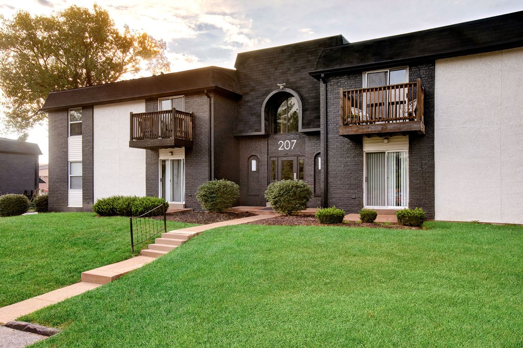 the view of a building with a yard and grass