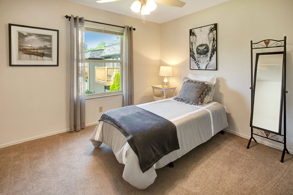 a bedroom with a bed and a window