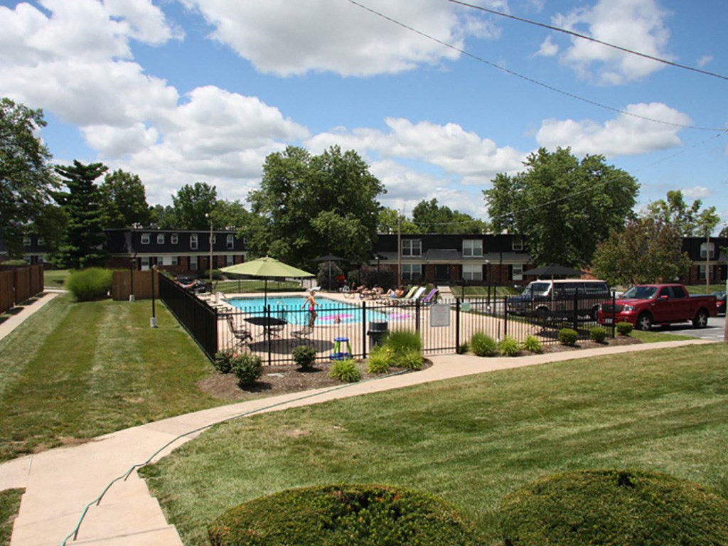a swimming pool in a yard with a fence