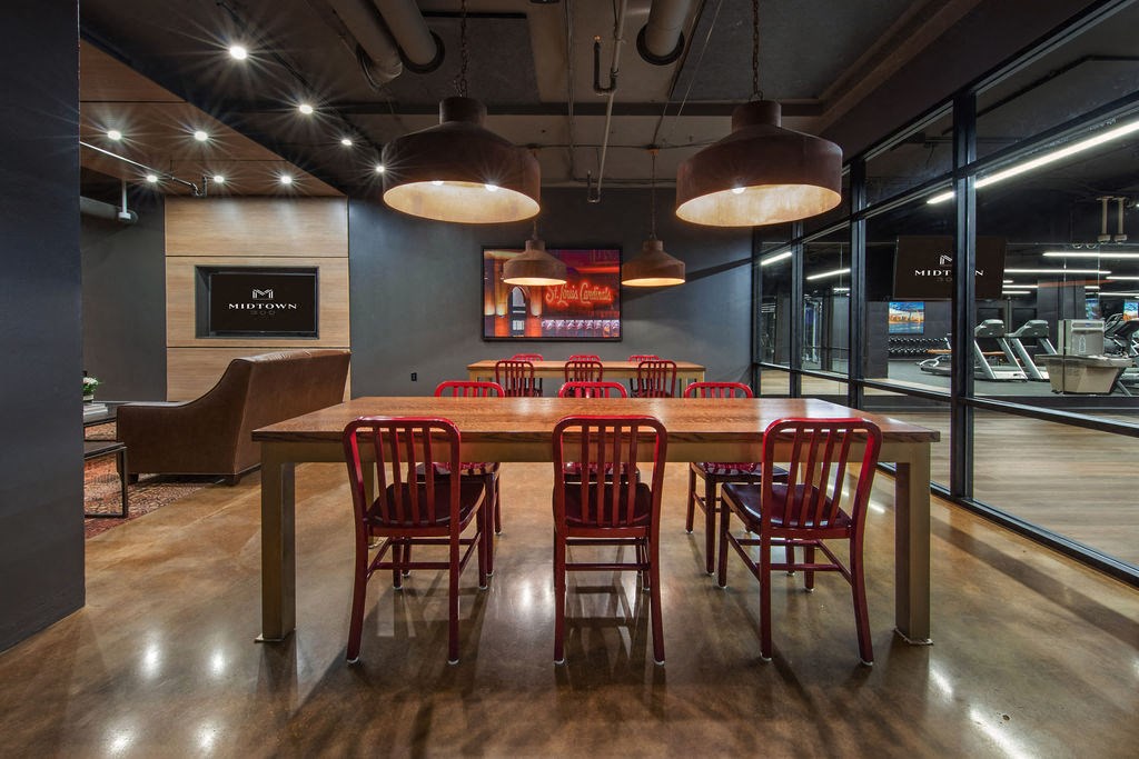 a large table in a restaurant with red chairs