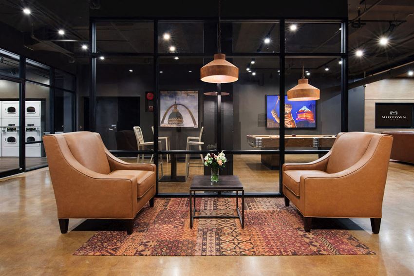 a lobby with two chairs and a coffee table