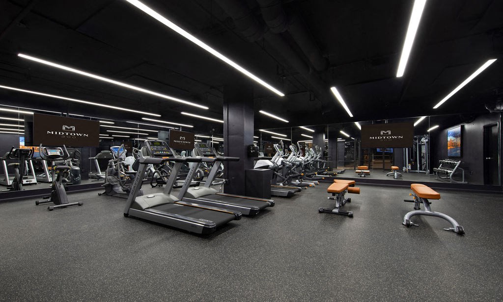 a rendering of a gym with cardio machines and weights