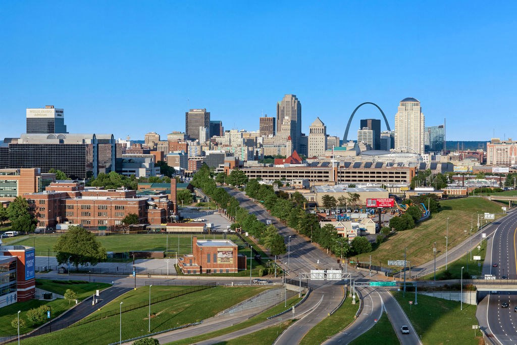 an aerial view of the city with the gateway arch
