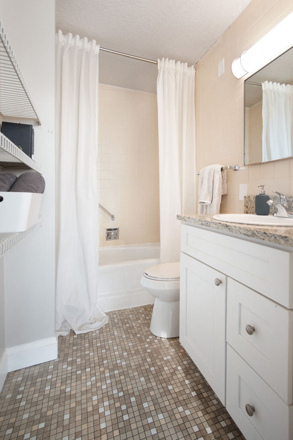 a bathroom with a toilet and a sink and a shower