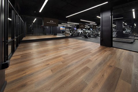 a fitness center with hardwood floors and a gym